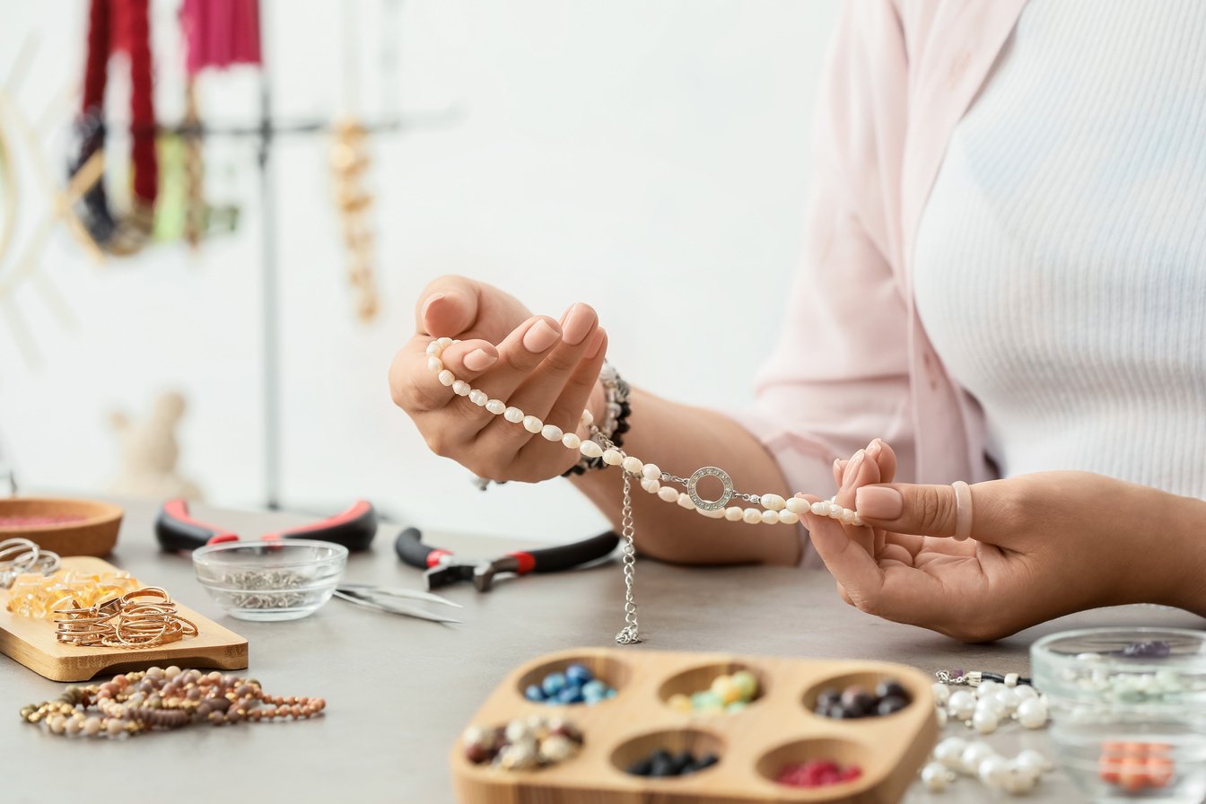 Female Designer Making Jewelry at Workplace